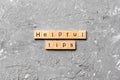 Helpful tips word written on wood block. helpful tips text on table, concept Royalty Free Stock Photo