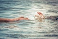 Helping adult hand reaching child hand drowning in water concept water rescue safety Royalty Free Stock Photo