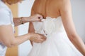 Helping the bride to put her wedding dress Royalty Free Stock Photo