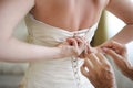 Helping the bride to put her wedding dress Royalty Free Stock Photo