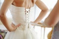 Helping the bride to put her wedding dress Royalty Free Stock Photo