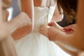 Helping the bride to put her wedding dress Royalty Free Stock Photo