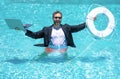 Helping business. Business man in suit hold laptop and help lifebuoy in swim pool. Rescue help swimming ring in water