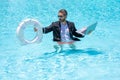 Helping businessman. Businessman in suit hold laptop and lifebuoy in sea beach water. Rescue businessman. Helping Royalty Free Stock Photo