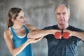 Helping, dumbbell and fitness with old man and personal trainer for support, health and physiotherapy. Training Royalty Free Stock Photo