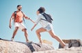 Helping hand, couple and rock climbing or hiking in nature on vacation, holiday or trip. Teamwork, support and traveling Royalty Free Stock Photo