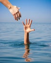 Helping hand giving to drowning man Royalty Free Stock Photo