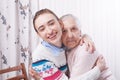 Helping hands, care for the elderly concept. Senior and caregiver holding hands at home Royalty Free Stock Photo