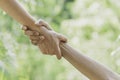 Helping hands concept. Hand holding for help on nature background Royalty Free Stock Photo