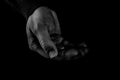 Helping hands concept, Man`s hands palms up holding money coins, need care and support, reaching out, black and white Royalty Free Stock Photo