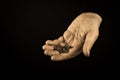 Helping hands concept, Rich giving the poor, Man`s hands palms up holding money coins, reaching out, compassion, aged photo amber