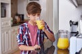 Helping himself to some juice. A young boy drinking a glass of orange juice. Royalty Free Stock Photo