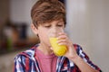 Helping himself to some juice. A young boy drinking a glass of orange juice. Royalty Free Stock Photo