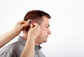 Helping in inserting hearing aid Royalty Free Stock Photo