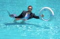 Helping summer business. Businessman in suit hold laptop and lifebuoy in sea beach water. Rescue businessman. Helping Royalty Free Stock Photo