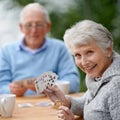 Helping the time pass with card games. Two seniors playing cards together. Royalty Free Stock Photo