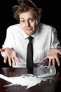 Helpless businessman with spilled milk on table