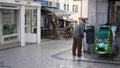 Helpless elderly man slowly walking with help of two cane sticks. old weak legs.