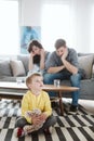 Helpless parents and their badly behaving son at home Royalty Free Stock Photo