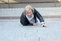 Helpless senior woman falling down steps