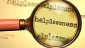 Helplessness and a magnifying glass on English word Helplessness to symbolize studying, examining or searching for an explanation