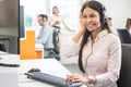 Helpline operator woman with headphones listening to a client in call centre. Royalty Free Stock Photo