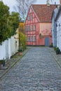 Helsingor city in winter with typical brick and wooden houses and stone road. It`s the place where William Shakespeare set the