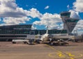 Helsinki Airport Finland 26.07.2019: Finnair airline technicians men load Luggage from container into the compartment in the tail