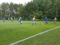 Helsinki Cup junior football tournament - two female teams playing on natural grass field Royalty Free Stock Photo