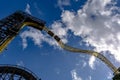 Train with 2 cars with people at Ukko roller coaster rail track in amusement park Royalty Free Stock Photo