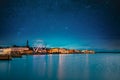 Helsinki, Finland. Bright Blue Starry Sky Above Embankment With Ferris Wheel In Evening Night Illuminations. Light Blue