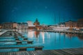 Helsinki, Finland. Bright Blue Starry Sky. View Of Evening City And Uspenski Cathedral From Pier. Light Blue Dramatic