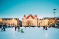 Helsinki, Finland. Children Skating On Rink On Railway Square On Background Of Finnish National Theatre In Winter Sunny