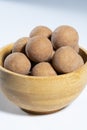 Traditional Finnish cuisine: A bowl of salty licorice coated traditional licorice against a white background