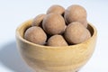 Traditional Finnish cuisine: A bowl of salty licorice coated traditional licorice against a white background