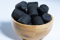 Traditional Finnish cuisine: A bowl of sweet black licorice against a white background
