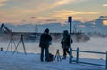 HELSINKI, FINLAND - JANUARY 8, 2015: Freezing photographers at harbor in winter