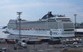 Cruise liner in the port of Helsinki. At the pier, a line of trucks for loading on a ferry Royalty Free Stock Photo