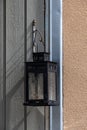 An old metallic lantern hanging against white wooden wall Royalty Free Stock Photo