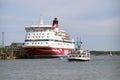 A tourist boat on the background of the sea cruise ferry `Gabriella` Royalty Free Stock Photo