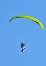 Pilot performing aerobatics stunts with a paramotor and Finnish flag at the Kaivopuisto Air Show in Helsinki, Finland.