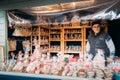 Helsinki, Finland. Man Selling Christmas Souvenirs Gifts In Form Of Confectionery From Gingerbread At European Winter