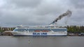 Black exhaust fumes coming from the chimney of an moored cargo-passenger cruise ferry ship Silja Serenade by Tallink after main