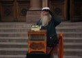 HELSINKI, FINLAND - NOVEMBER 25, 2008: elderly organ grinder on the streets