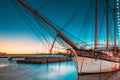 Helsinki, Finland. Old Wooden Sailing Vessel Ship Schooner Is Moored To City Pier, Jetty. Lighting At Evening Or Night Royalty Free Stock Photo