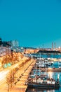 Helsinki, Finland. View Of Pohjoisranta Street And Ships, Boats And Yachts Moored Near Pier In Evening Night