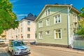 Helsinki - June 2019, Finland: Beautiful street with colorful houses in the traditional architectural style and parked cars