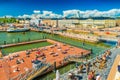 Helsinki - June 2019, Finland: Cityscape of Helsinki harbour with people taking sun bath on a pier