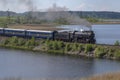 Steam locomotive L-0522 with tourist retro train `Ruskeala Express` on the dam