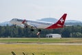Helvetic Airways Embraer E-190LR jet is landing on runway 14 in Zurich in Switzerland Royalty Free Stock Photo